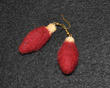 Red earings shaped like Christmas tree light bulbs