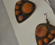 Rust and tan-colored guitar pick-shaped earings